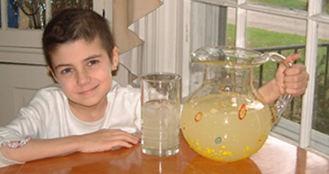 Alex Scott from Alex’s Lemonade Stand Foundation holding a pitcher of lemonade